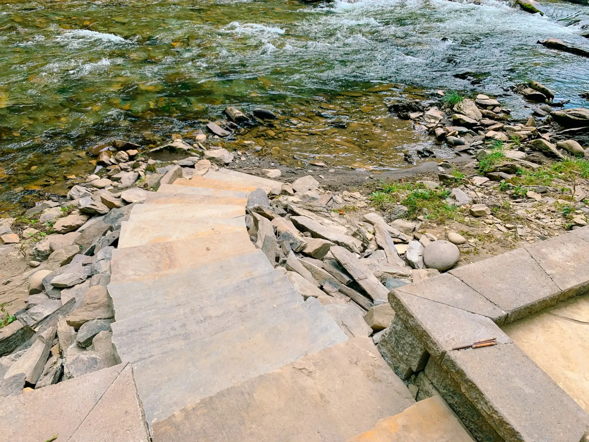 A set of stairs leading down to a river.