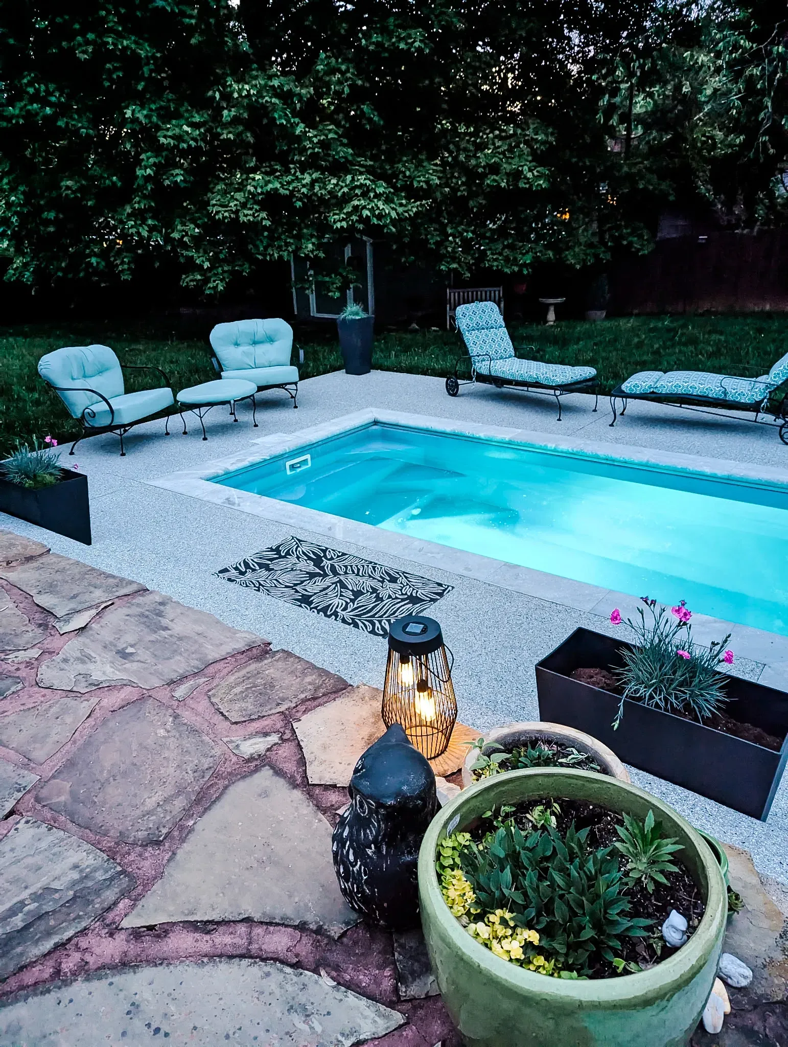 A large swimming pool in the backyard of a house