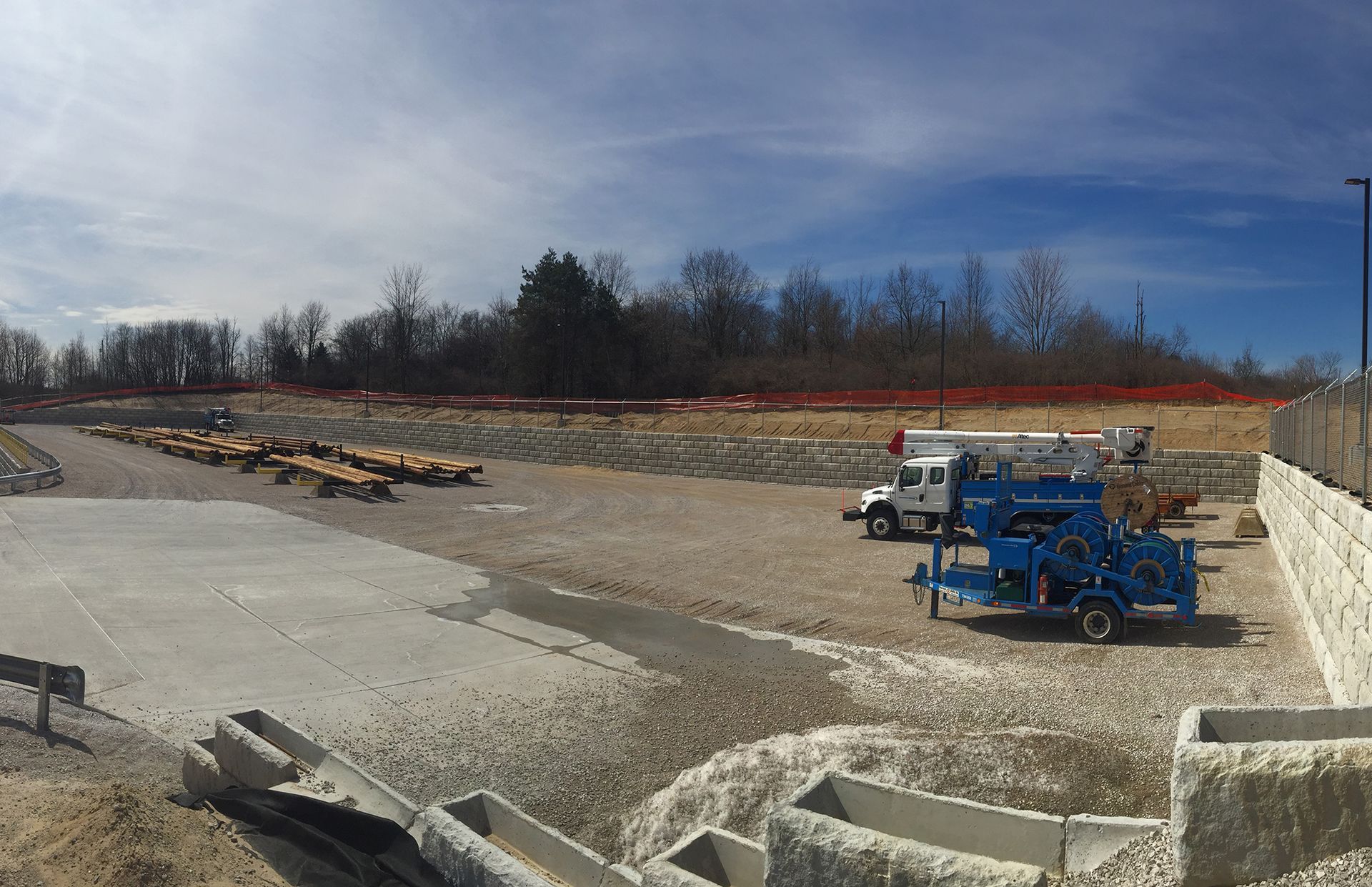 A construction site with a lot of trucks and trailers