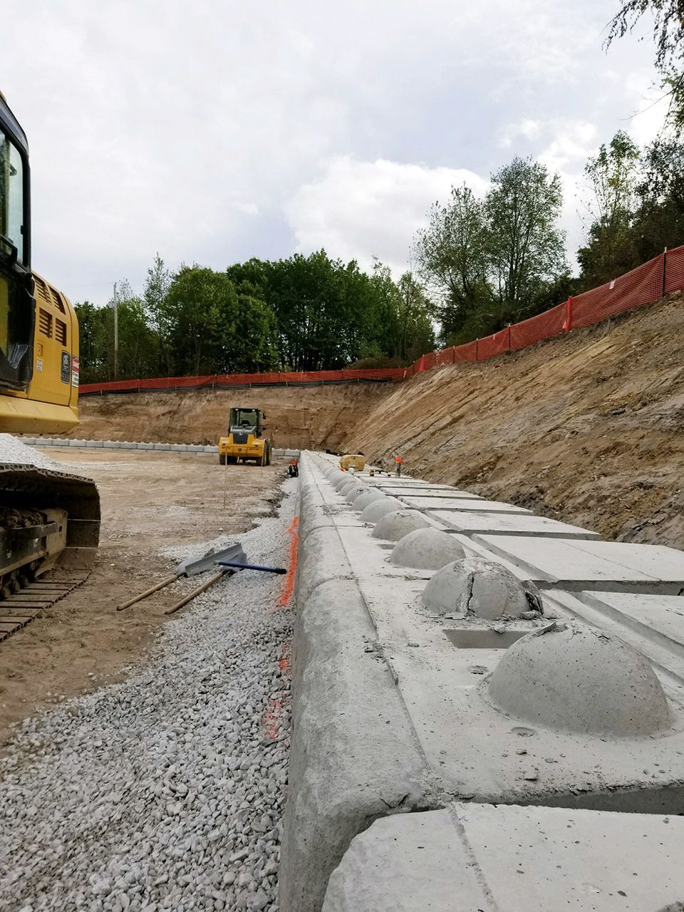 A construction site with a yellow bulldozer in the background