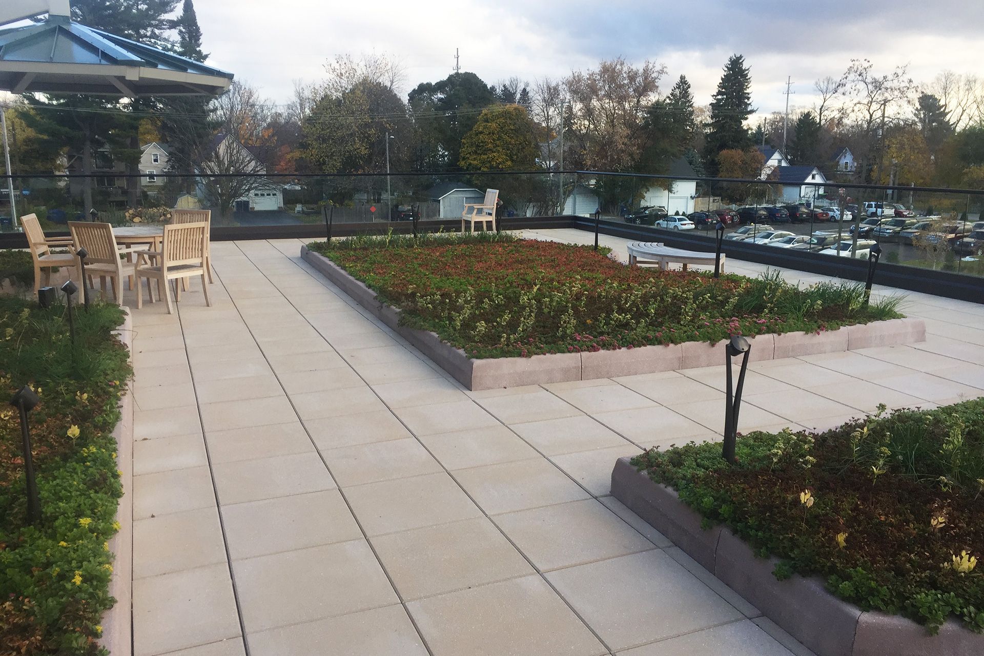 A patio with tables and chairs and a gazebo in the background