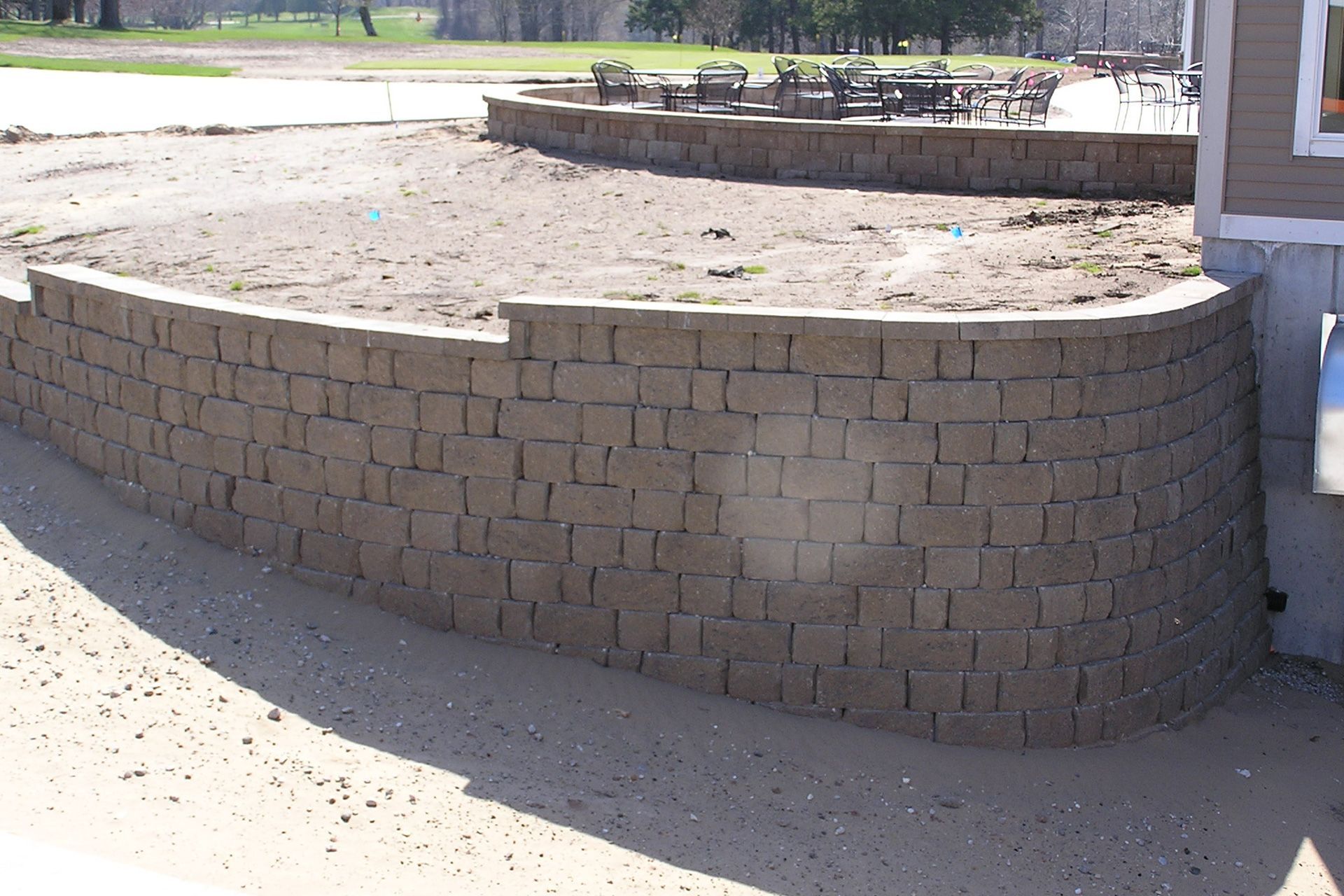 A brick wall is being built in front of a house