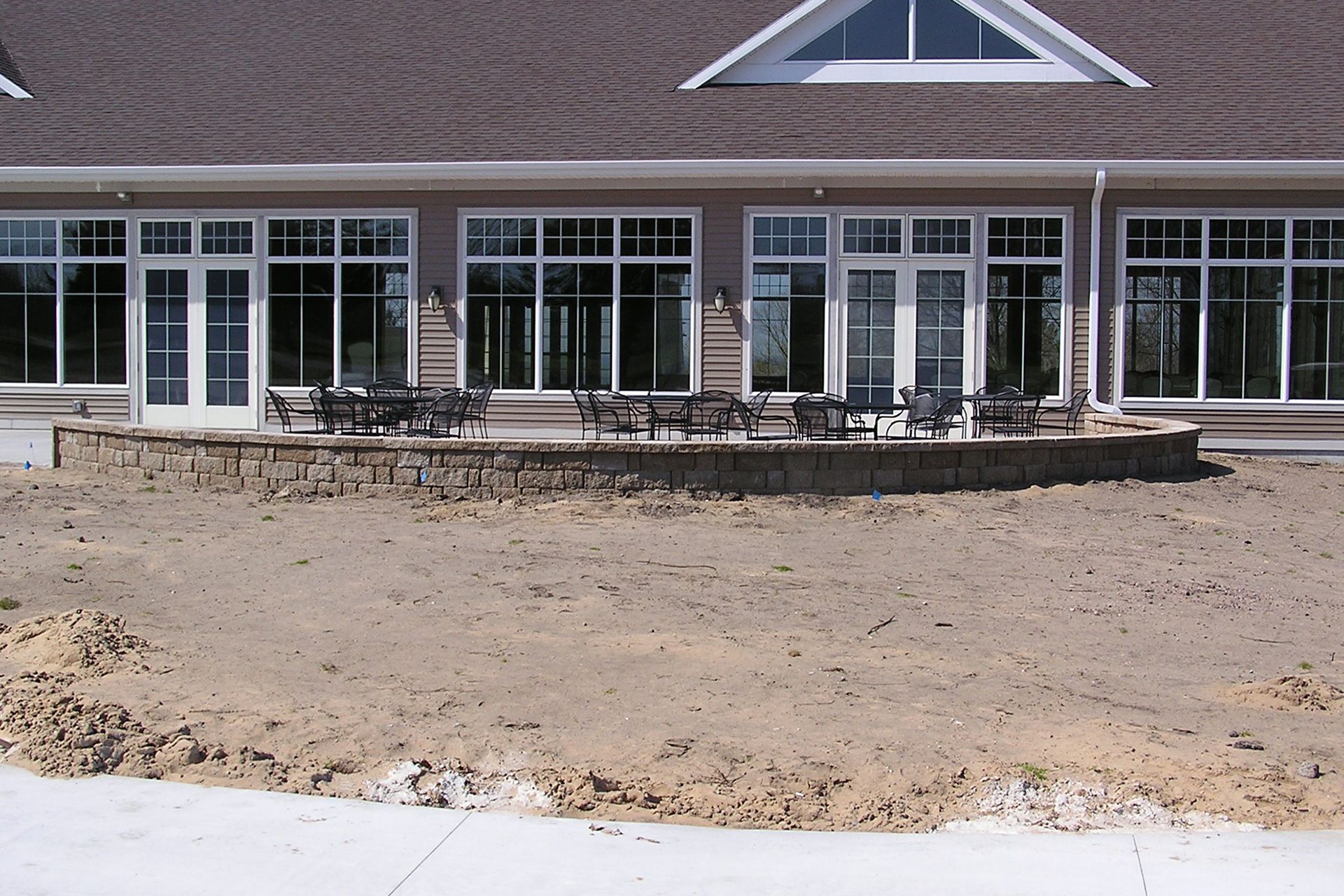 A large house with a lot of windows and tables and chairs