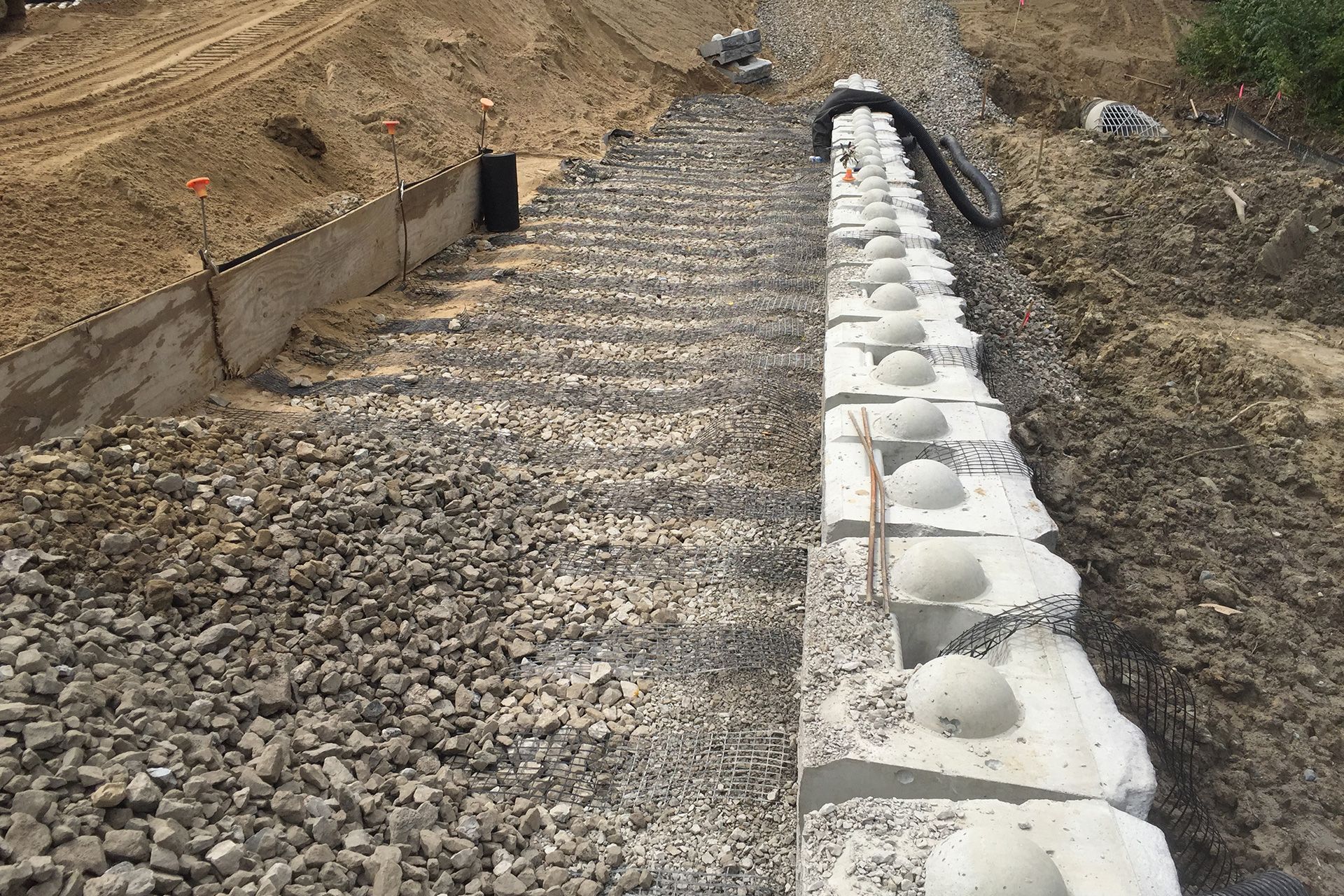 A concrete wall is being built on top of a pile of gravel.