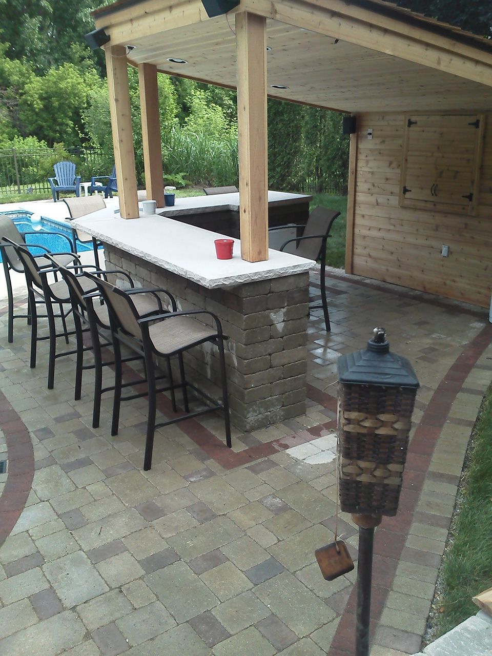 A patio with a table and chairs and a lantern