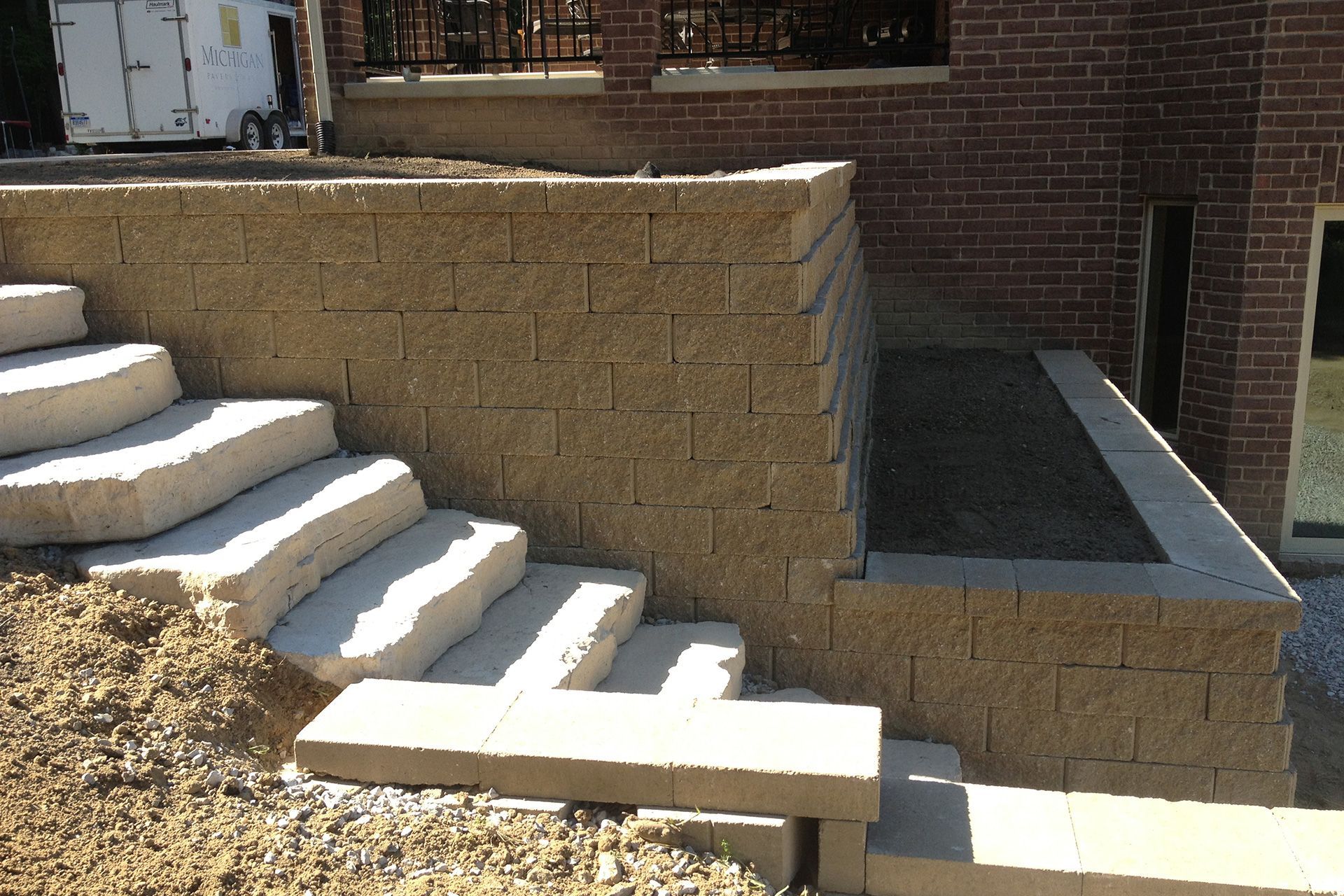 A set of stairs leading up to a brick wall