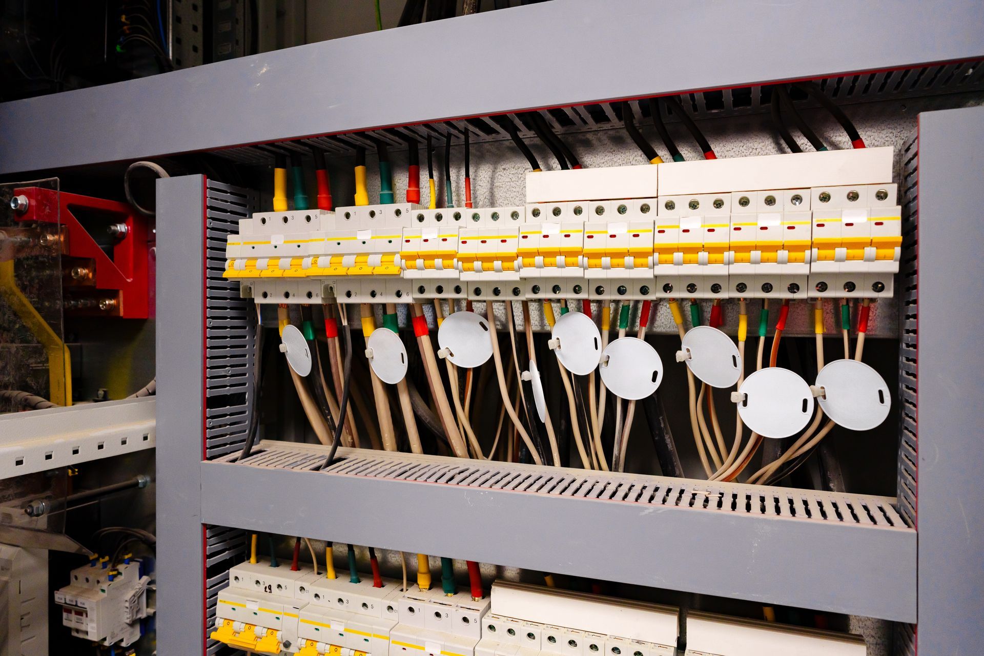 Electrical panel with rows of circuit breakers and wiring.