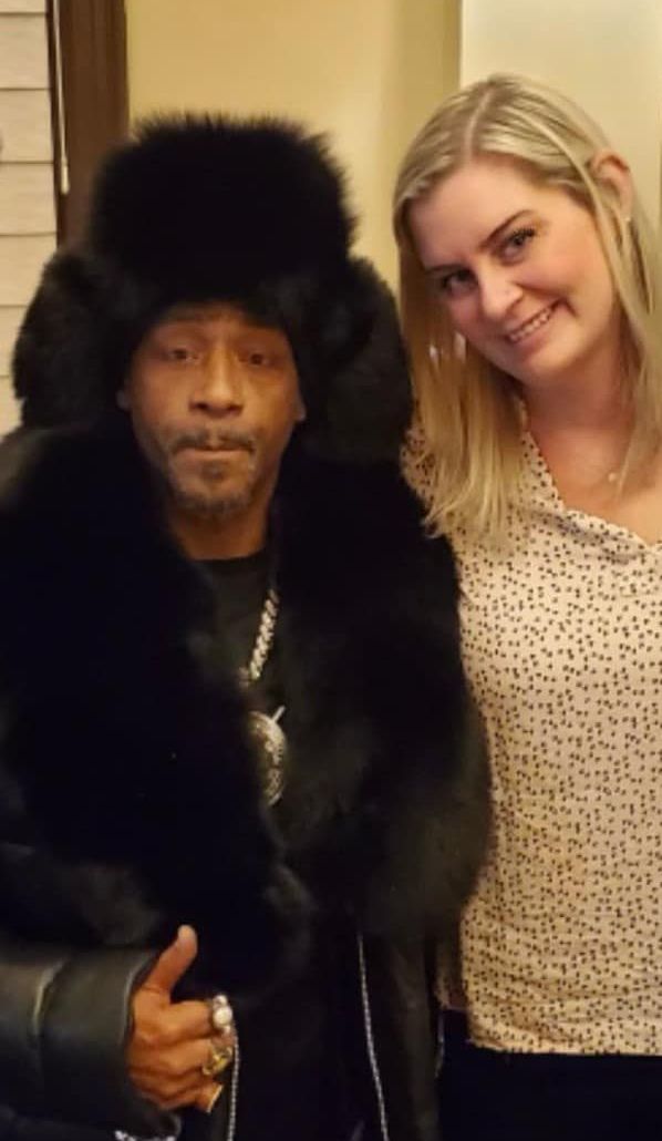 two women are standing next to each other in a living room .