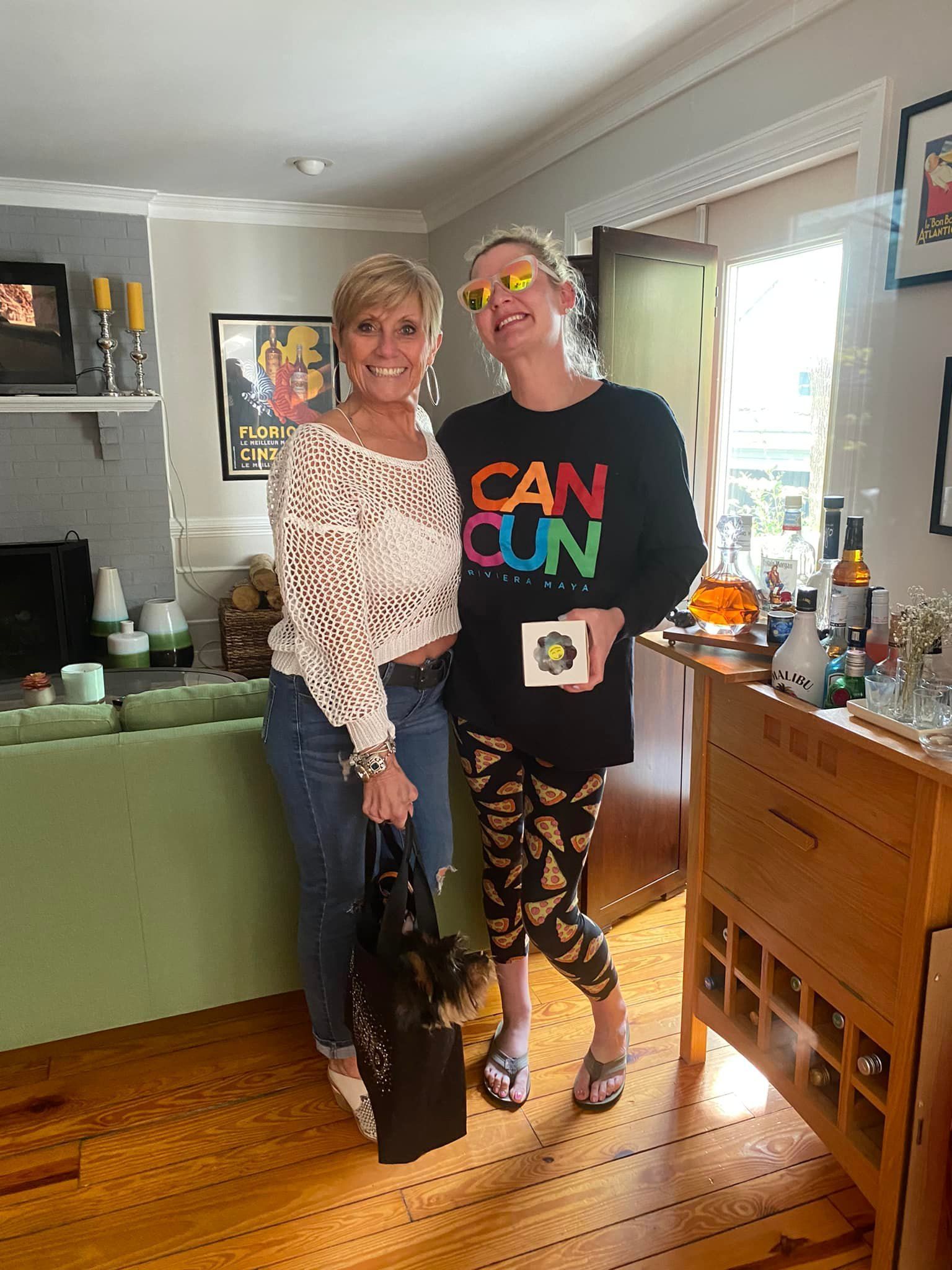 two women wearing headphones are sitting at a table in front of microphones .
