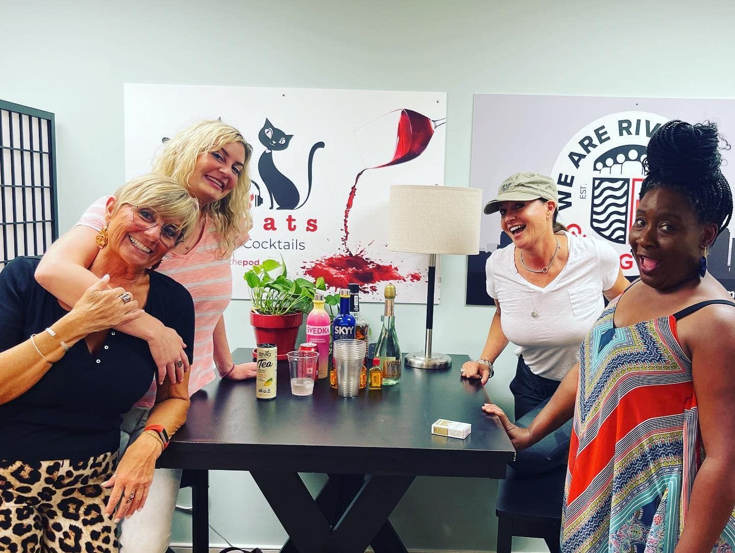 a group of women are posing for a picture in front of a table .