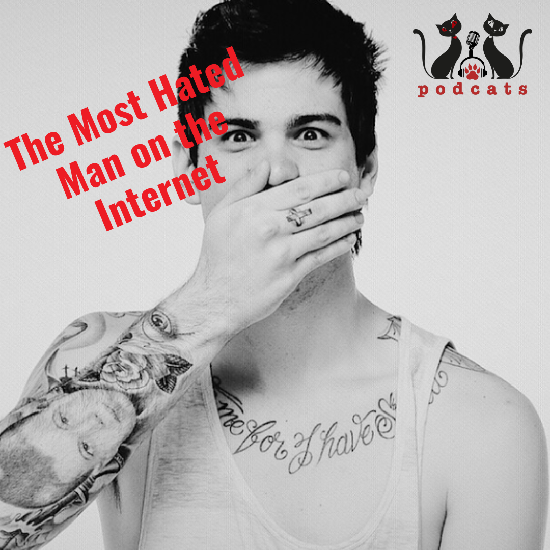 A man with a tattoo on his arm covering his mouth with his hand