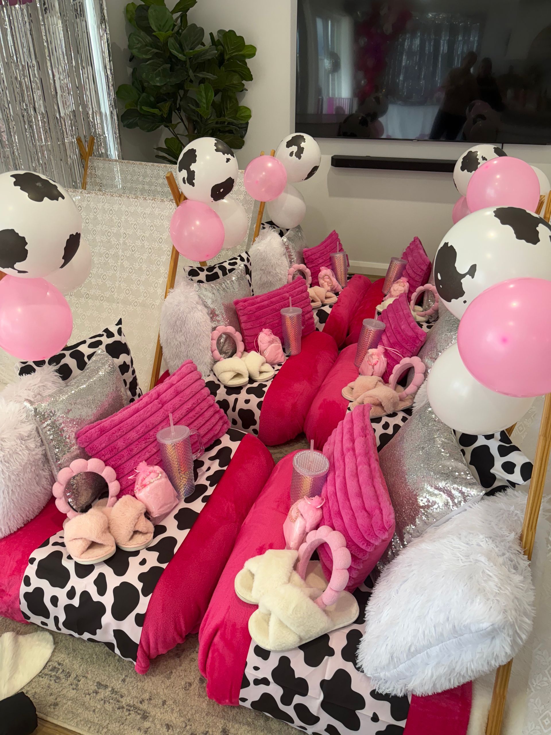 Pink gift baskets and cow-print balloons arranged on a table for a celebration — Sweet Parties & Braids in Tatton, NSW
