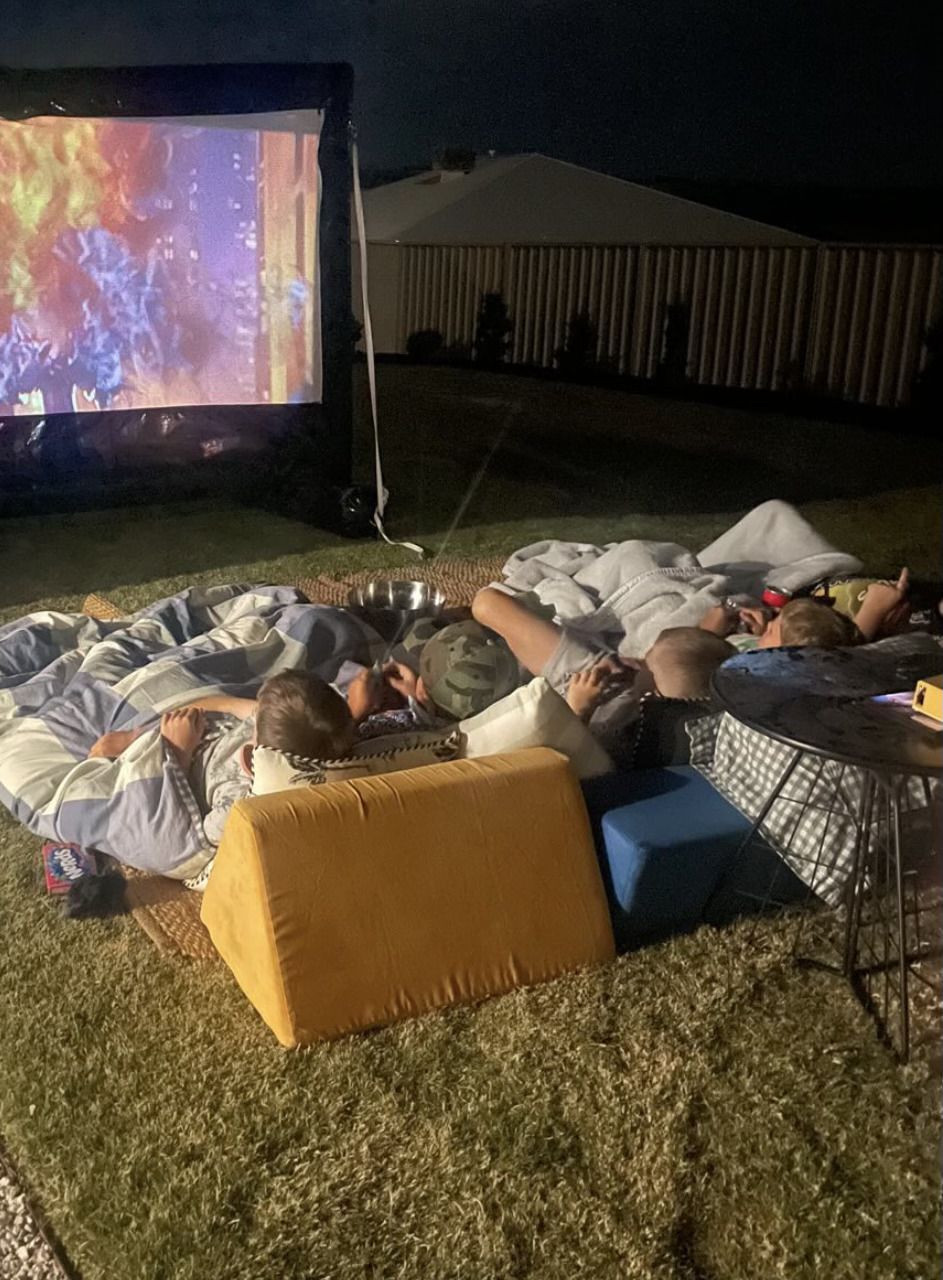 Young girl Watching movie Outdoor while Eating Popcorn — Sweet Parties & Braids in Tatton, NSW