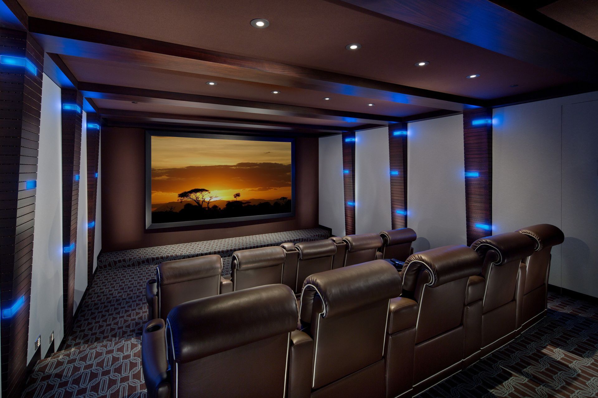 a home theater with a sunset on the screen