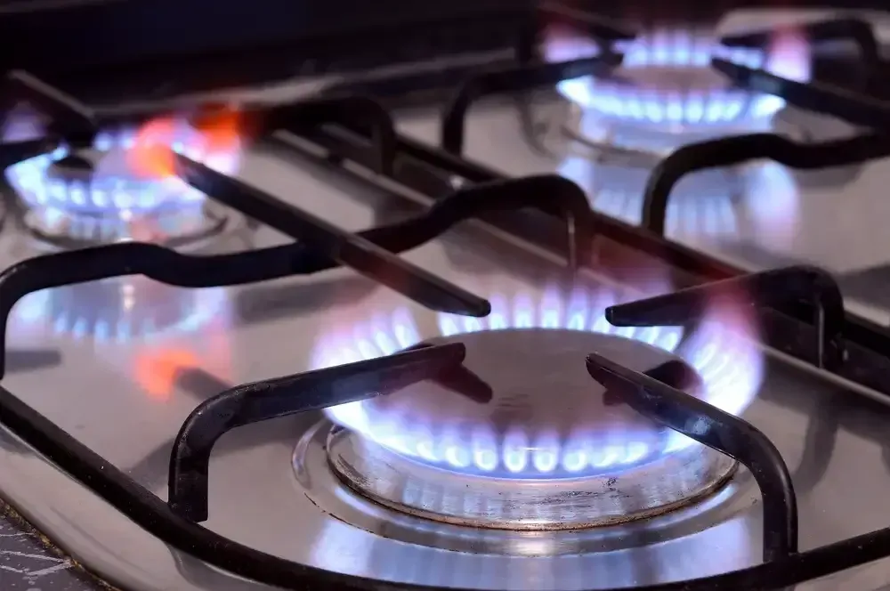 A Close Up Of A Gas Stove With Flames Coming Out Of It — Bennett Plumbing In Shellharbour, NSW