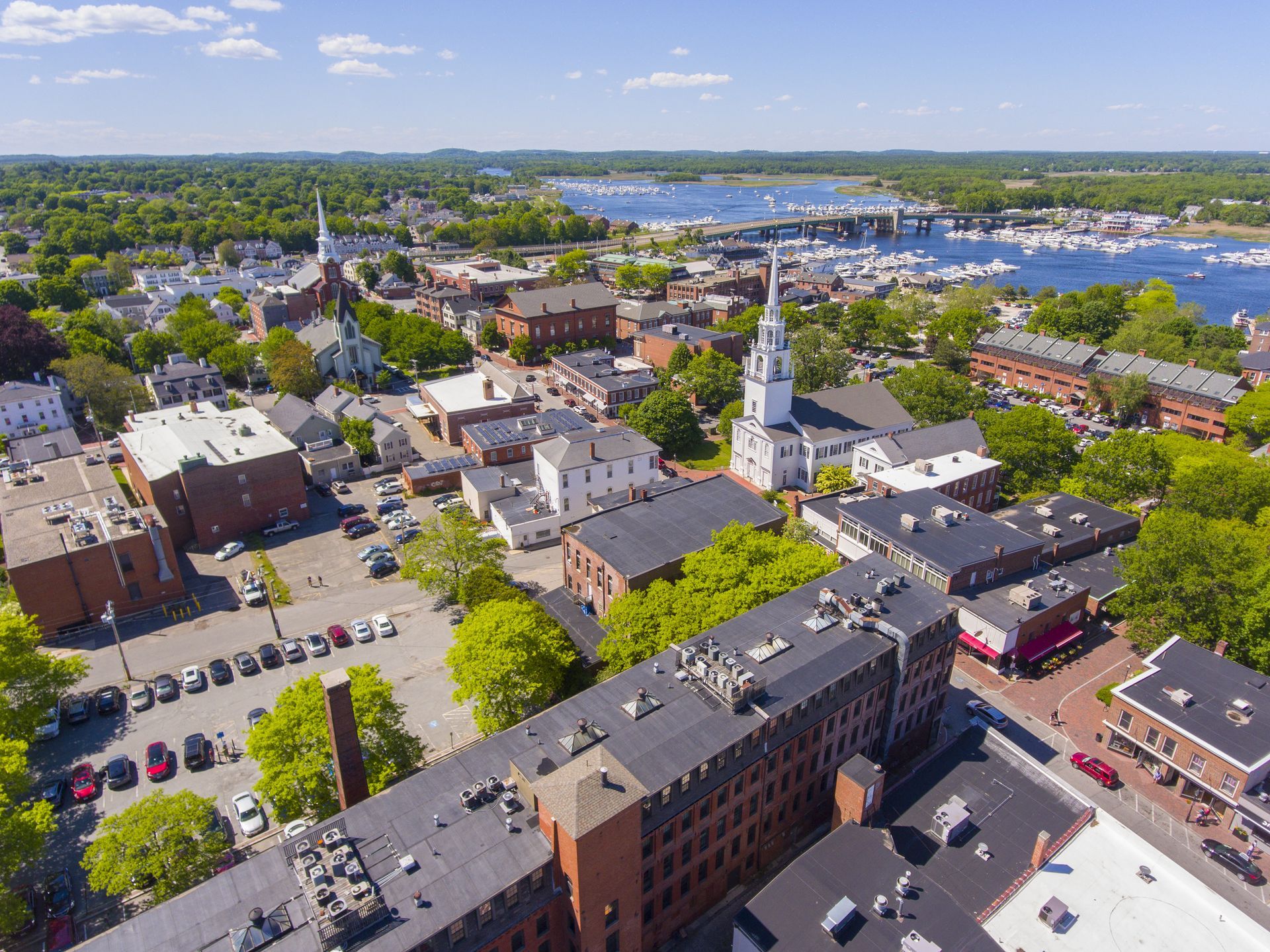 An aerial view of a small town with a clock tower in the middle of it.