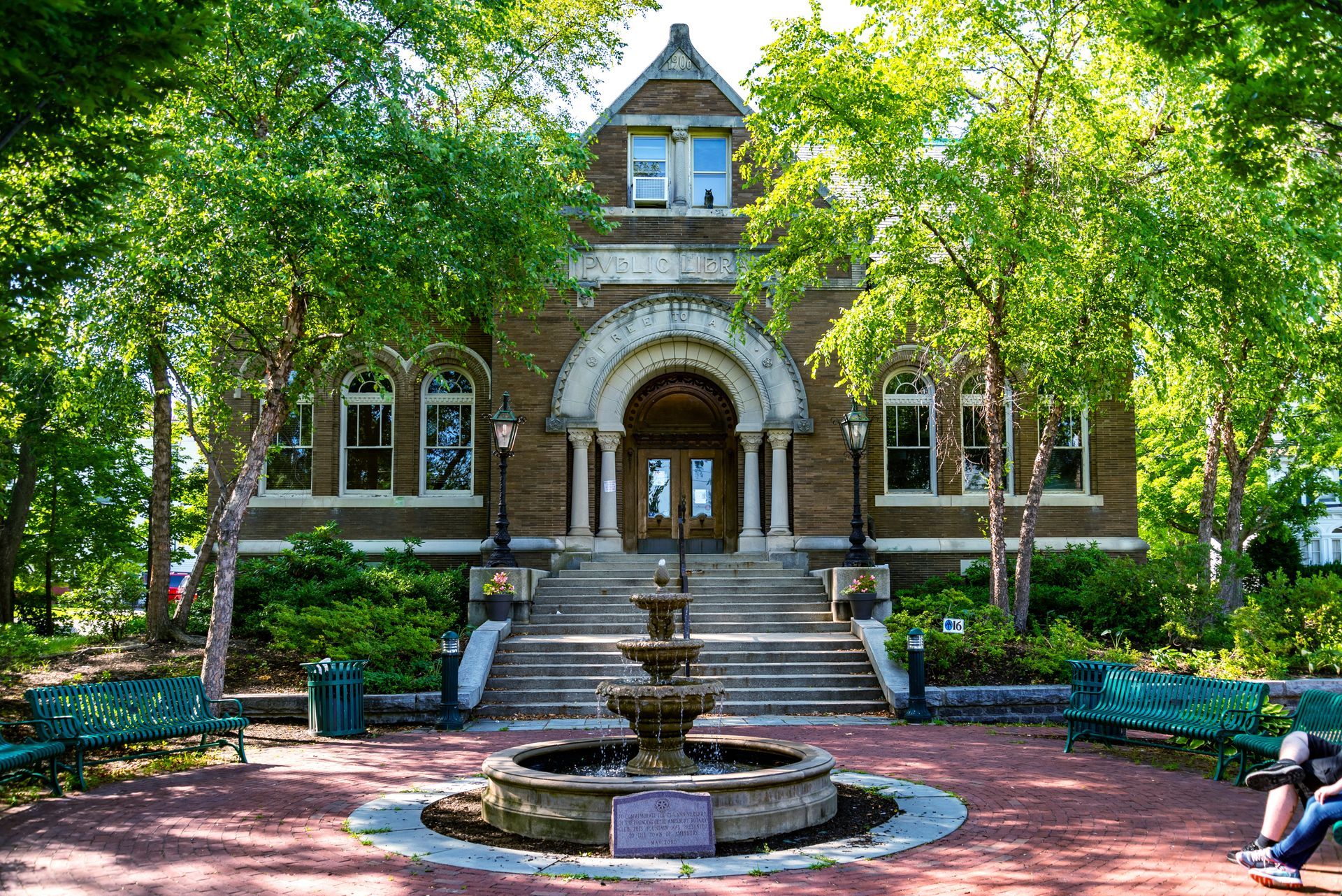 A brick building with a fountain in front of it
