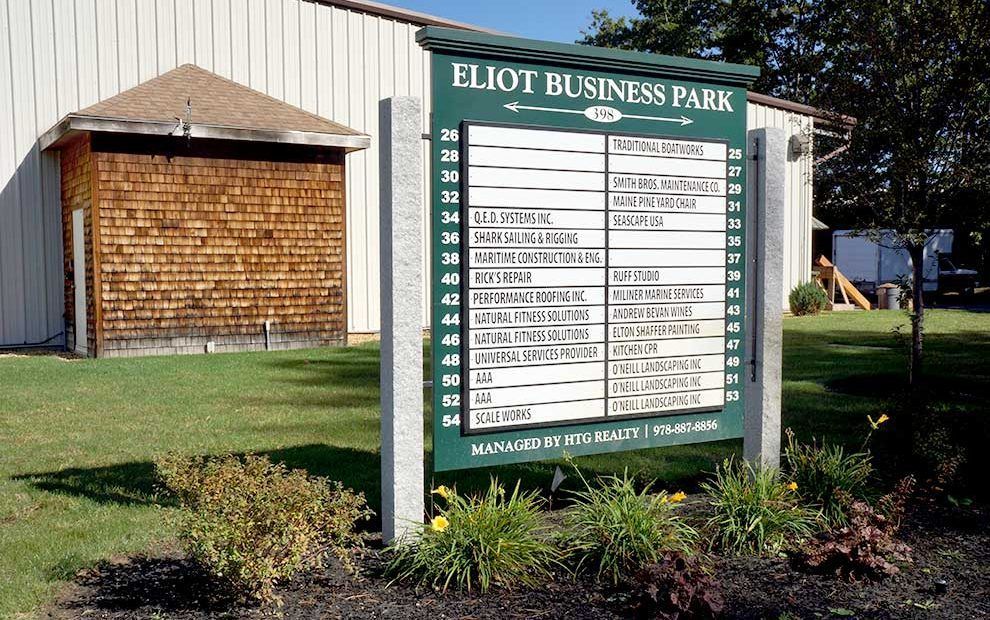 A sign for eliot business park is in front of a building