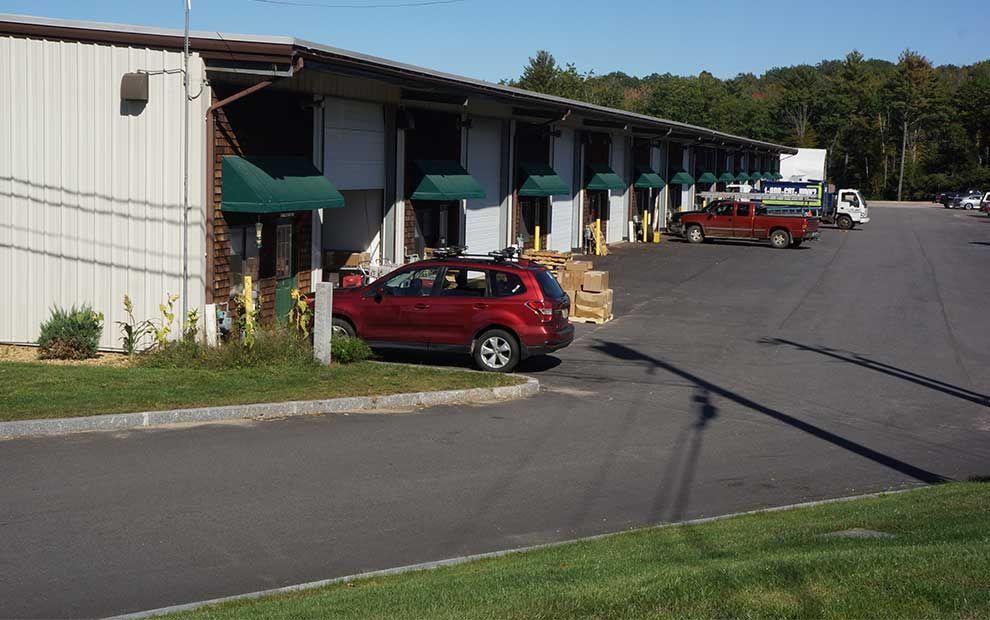 A red car is parked in front of a building.