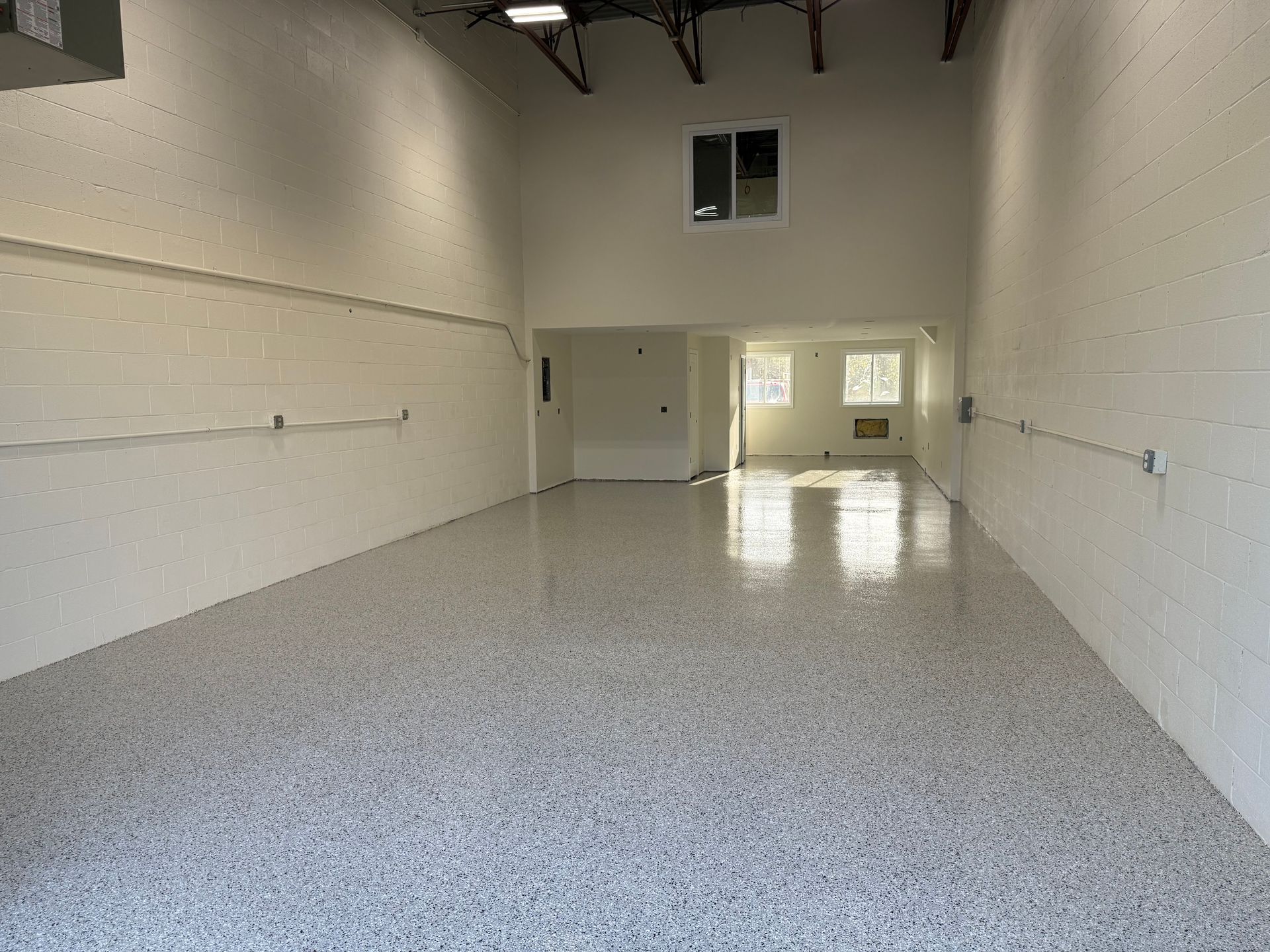 A large empty room with white walls and a white floor.