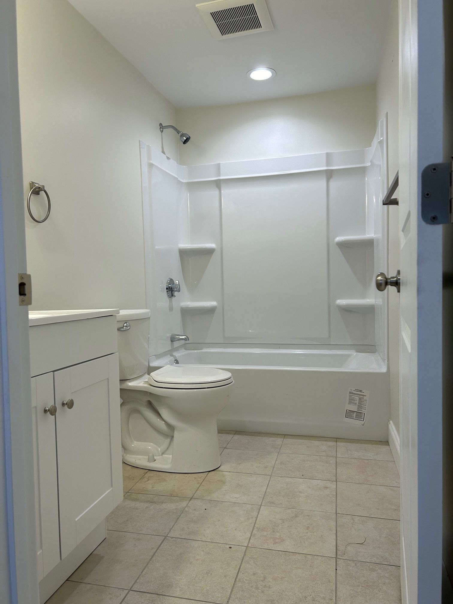 A bathroom with a toilet , sink , tub and shower.