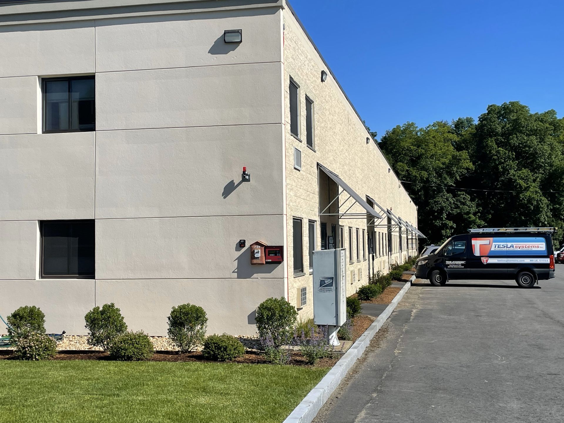 A white building with a van parked in front of it