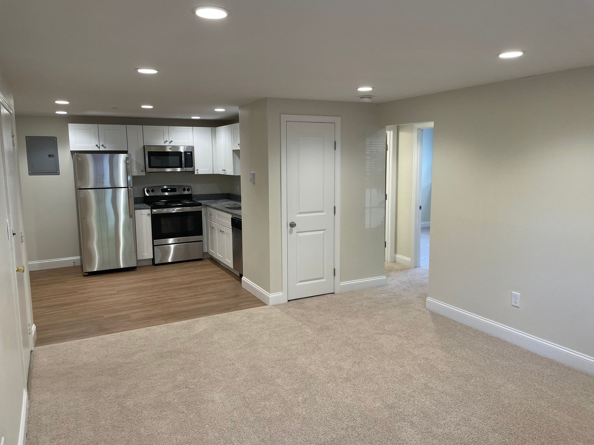 A kitchen with stainless steel appliances and a refrigerator