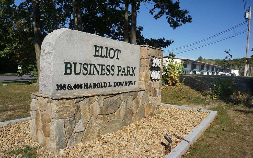 A large stone sign for eliot business park
