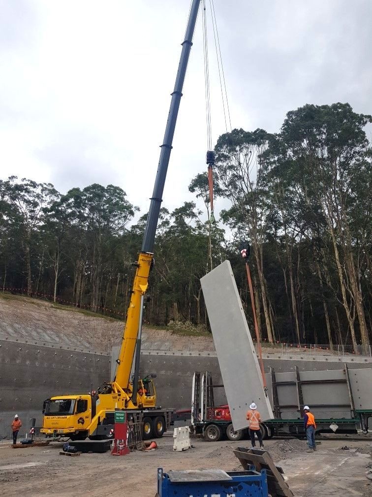 A Large Yellow Crane Is Lifting A Large Piece Of Concrete — All Lift Cranes In Vincentia, NSW