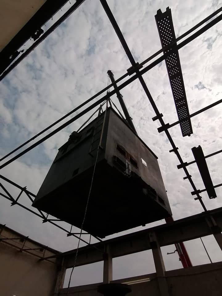 A Large Black Box Is Being Lifted Into The Air By A Crane — All Lift Cranes In St Georges Basin, NSW