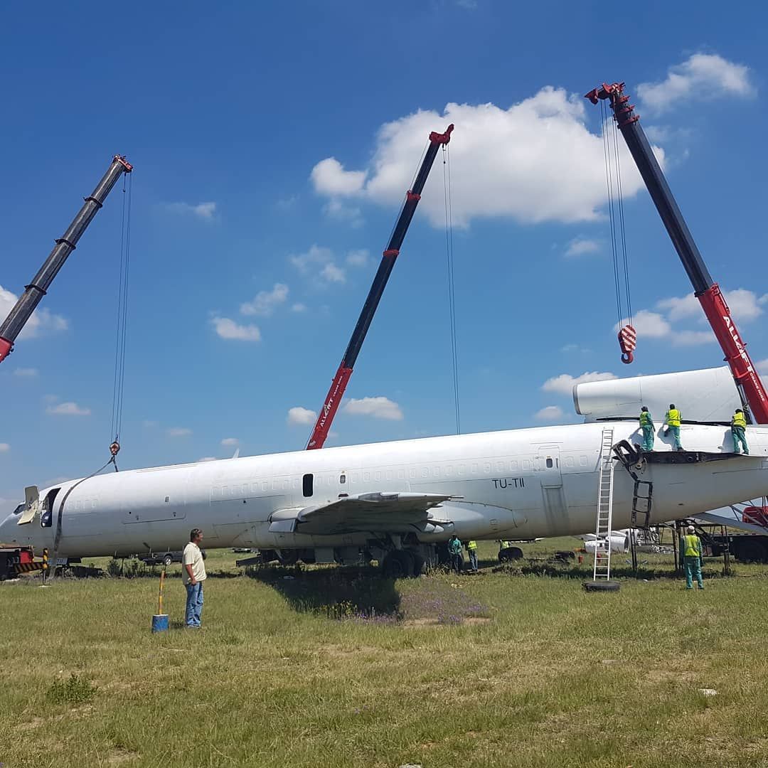 A Large White Airplane Is Being Lifted By Two Cranes — All Lift Cranes In Batemans Bay, NSW