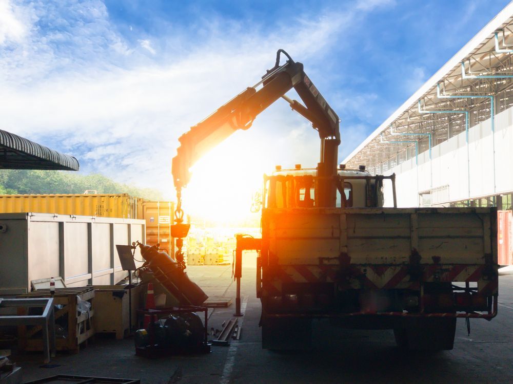 A Truck With A Crane Attached To It Is Parked In Front Of A Building — All Lift Cranes In St Georges Basin, NSW