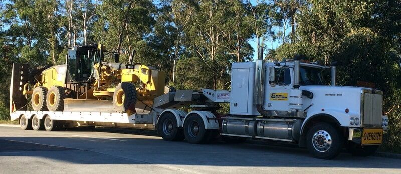 The Haulage Truck Loading an Excavator — Elmac Plant Hire In Taree