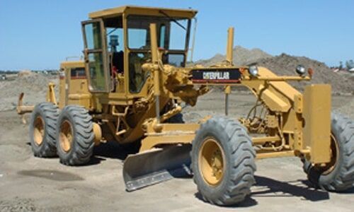 Yellow Grader in Dirt Field — Elmac Plant Hire In Taree