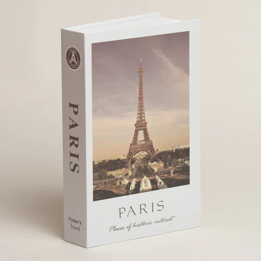 Una caja blanca decorativa para libros con una foto de la Torre Eiffel, etiquetada como 