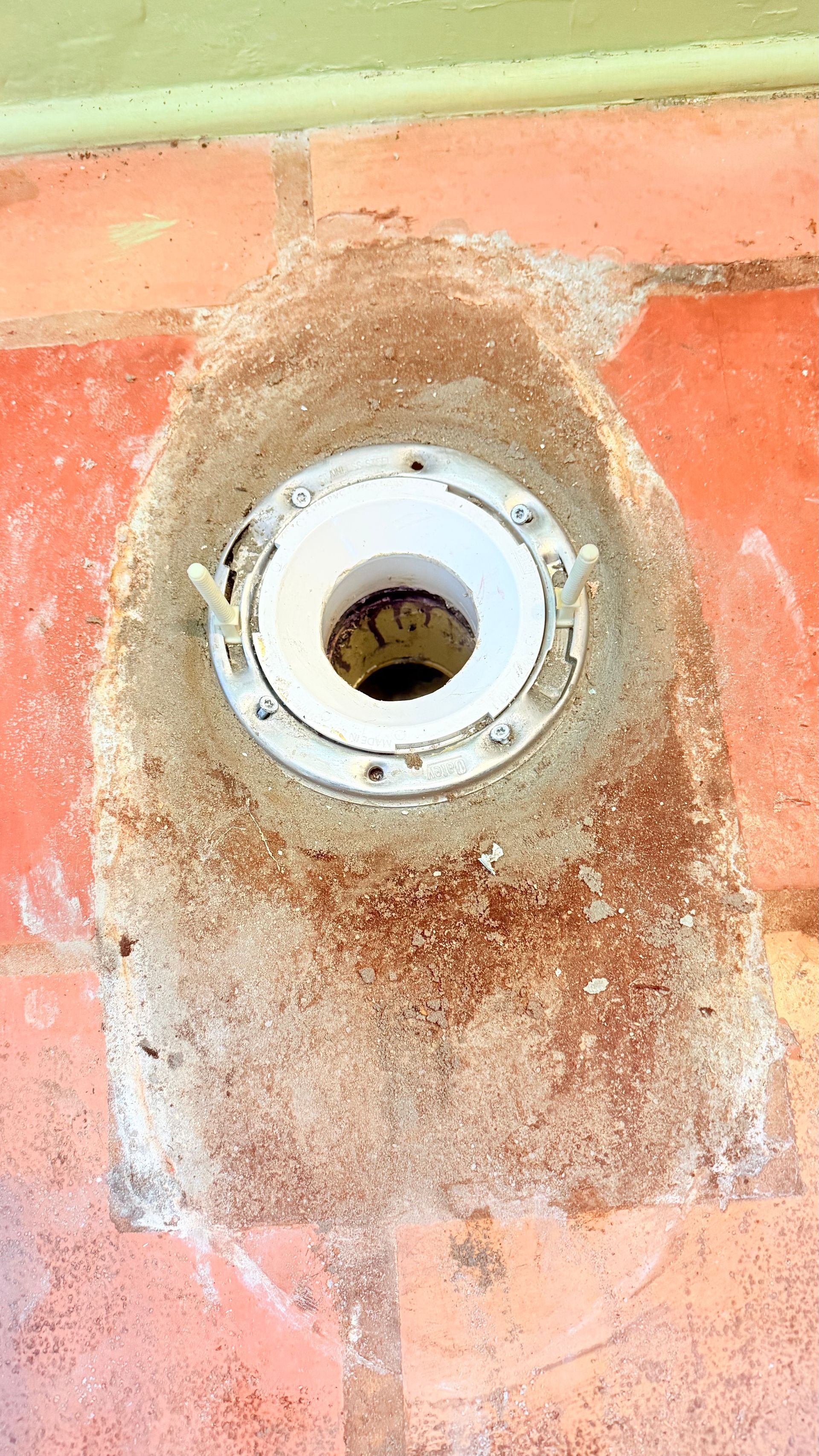 Plumber using a plunger on a white sink in a tiled bathroom. Plumber using a plunger on a white sink in a tiled bathroom.