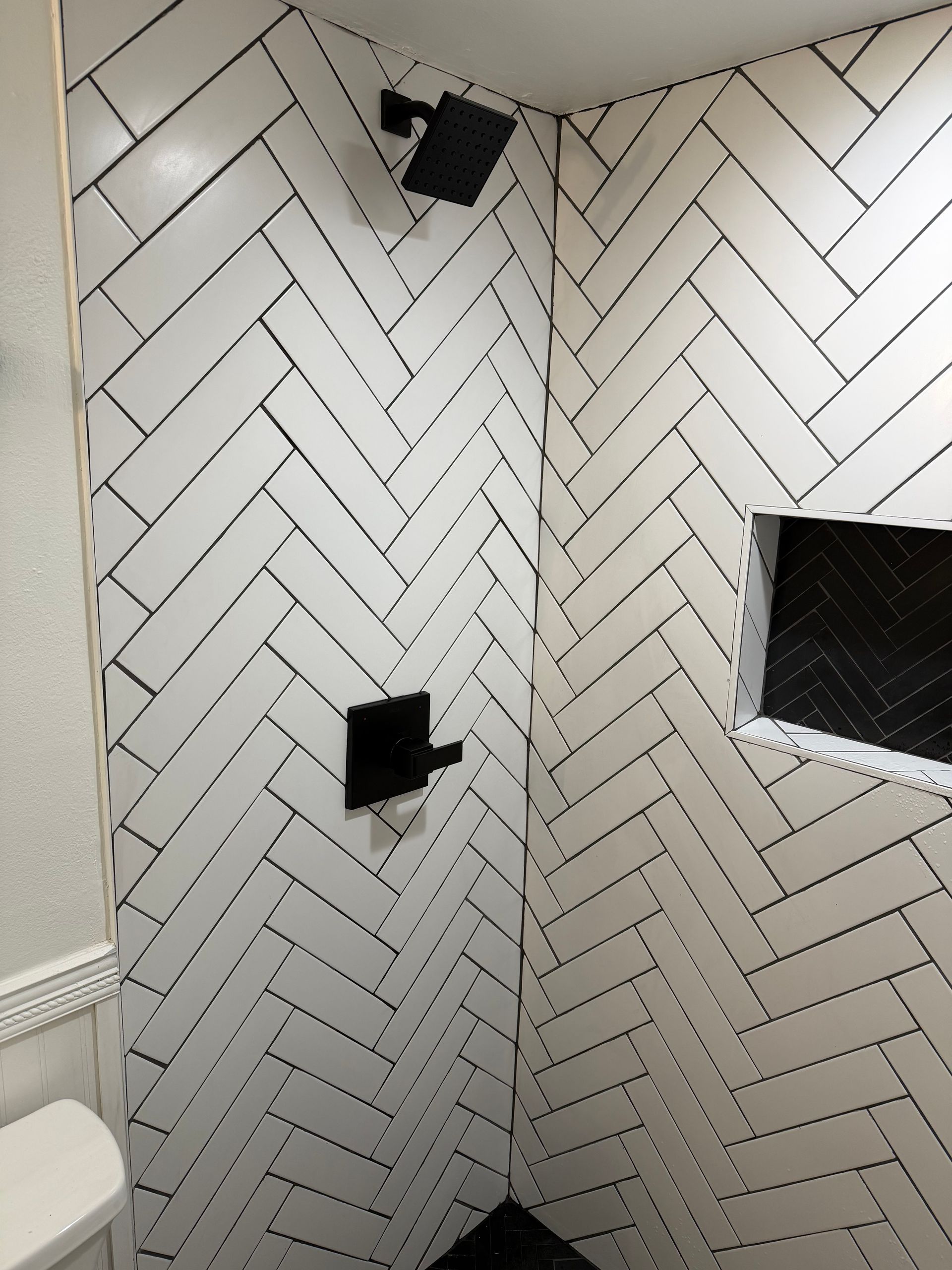 Person under a sink, working on plumbing. Person under a sink, working on plumbing.