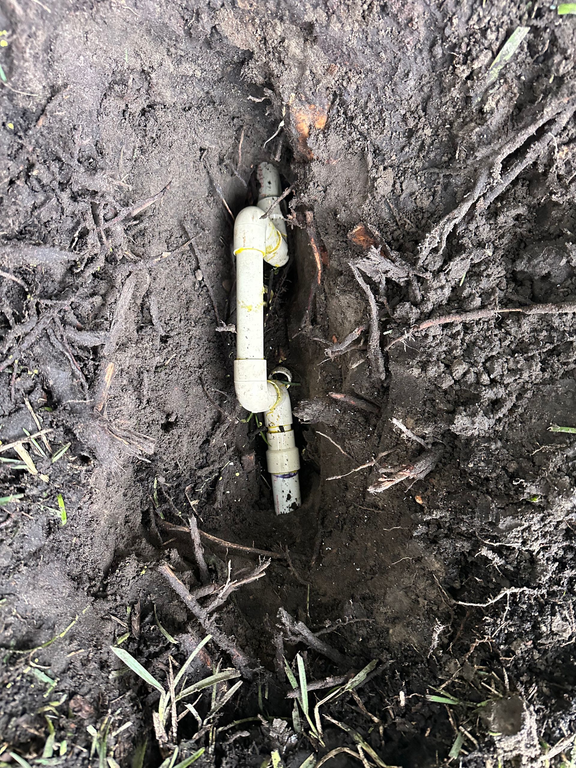 Woman pointing to sink while speaking to a plumber in a kitchen. He holds a toolbox. Woman pointing to sink while speaking to a plumber in a kitchen. He holds a toolbox.