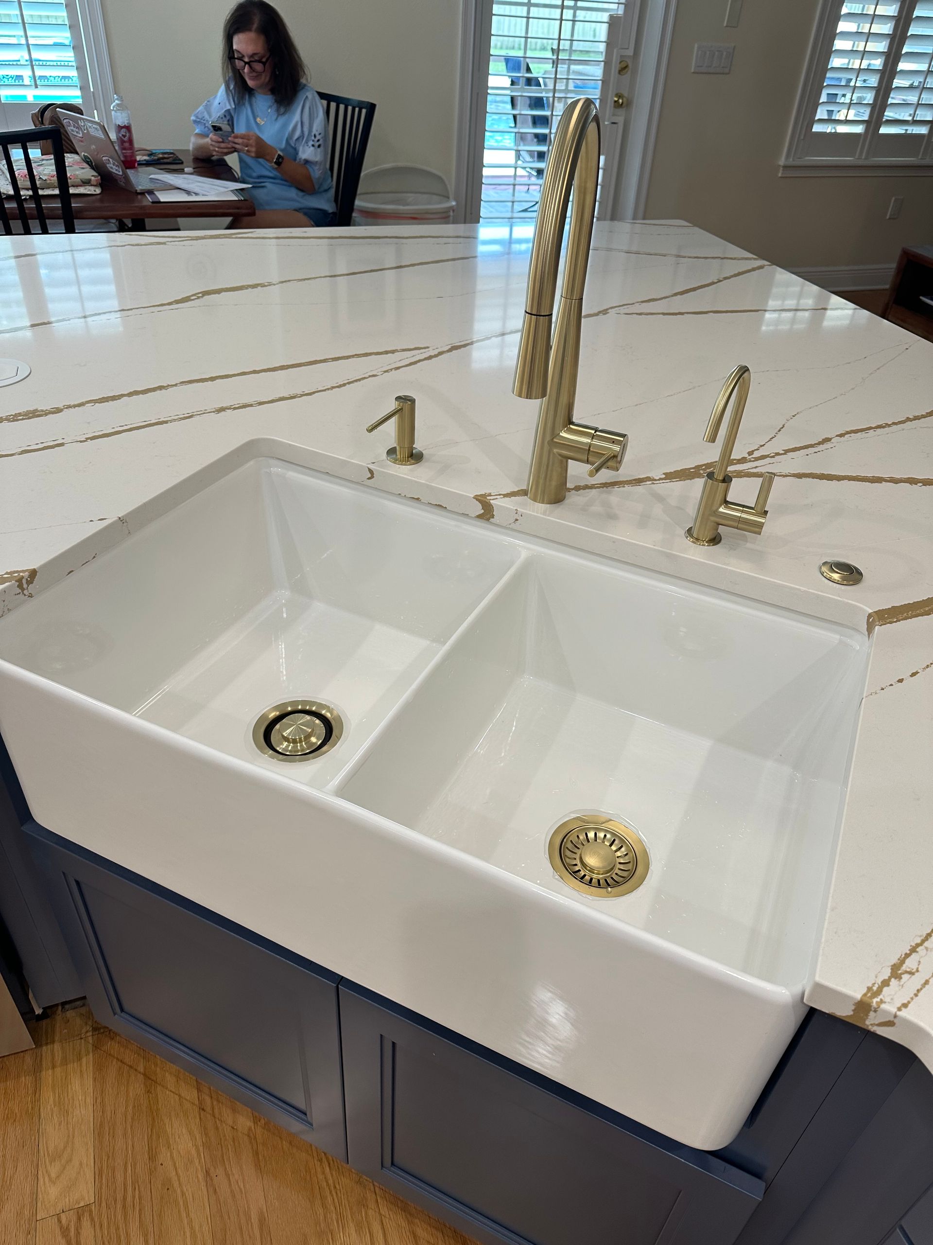 Woman in hard hat inspecting plumbing in a partially constructed building. Woman in hard hat inspecting plumbing in a partially constructed building.