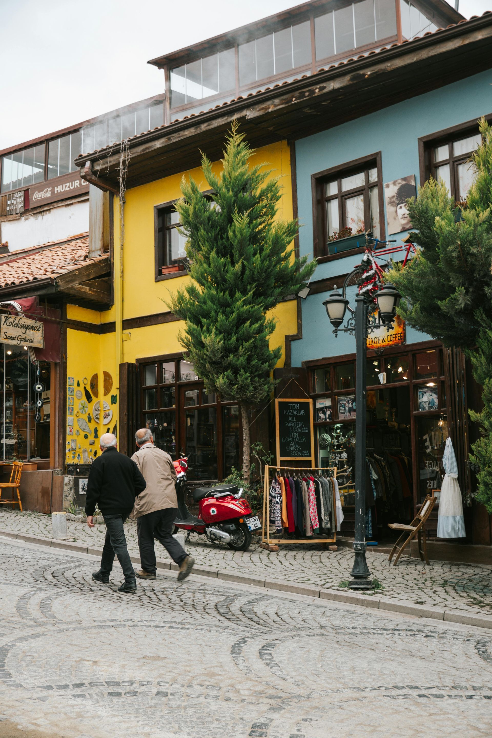 A barista taking an order from two customers at a cafe counter.