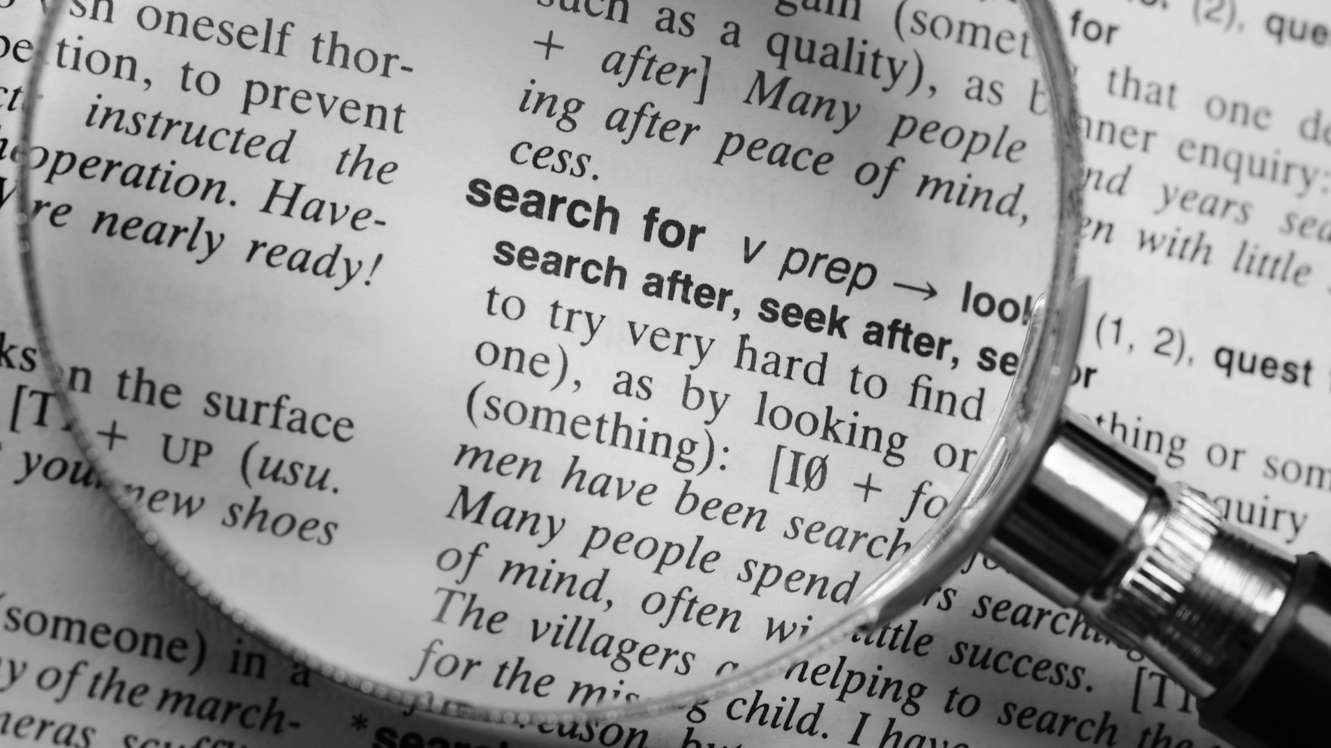 Magnifying glass over a dictionary entry for