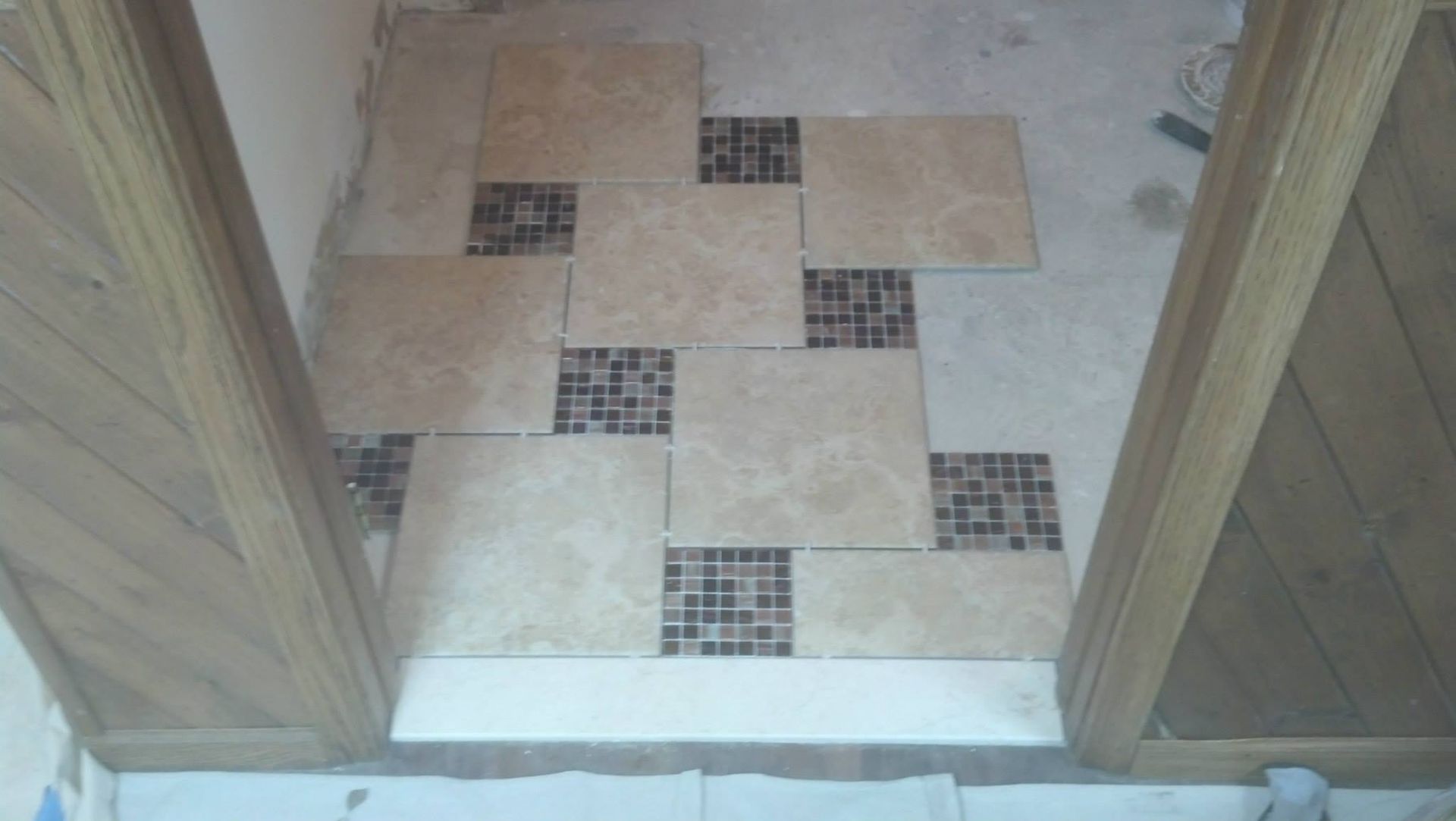 A room with a tiled floor and a wooden door