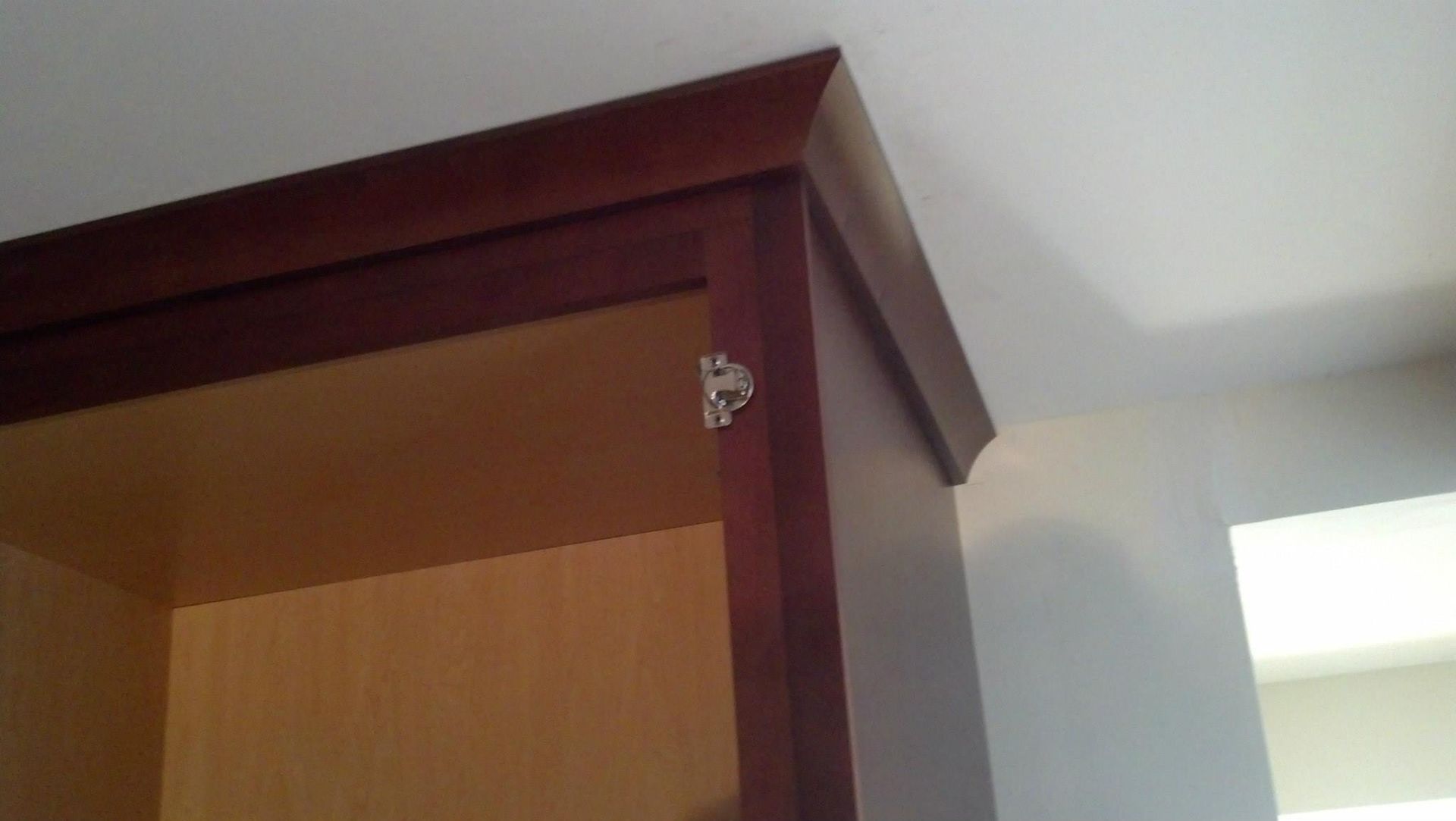 A close up of a wooden cabinet with the door open