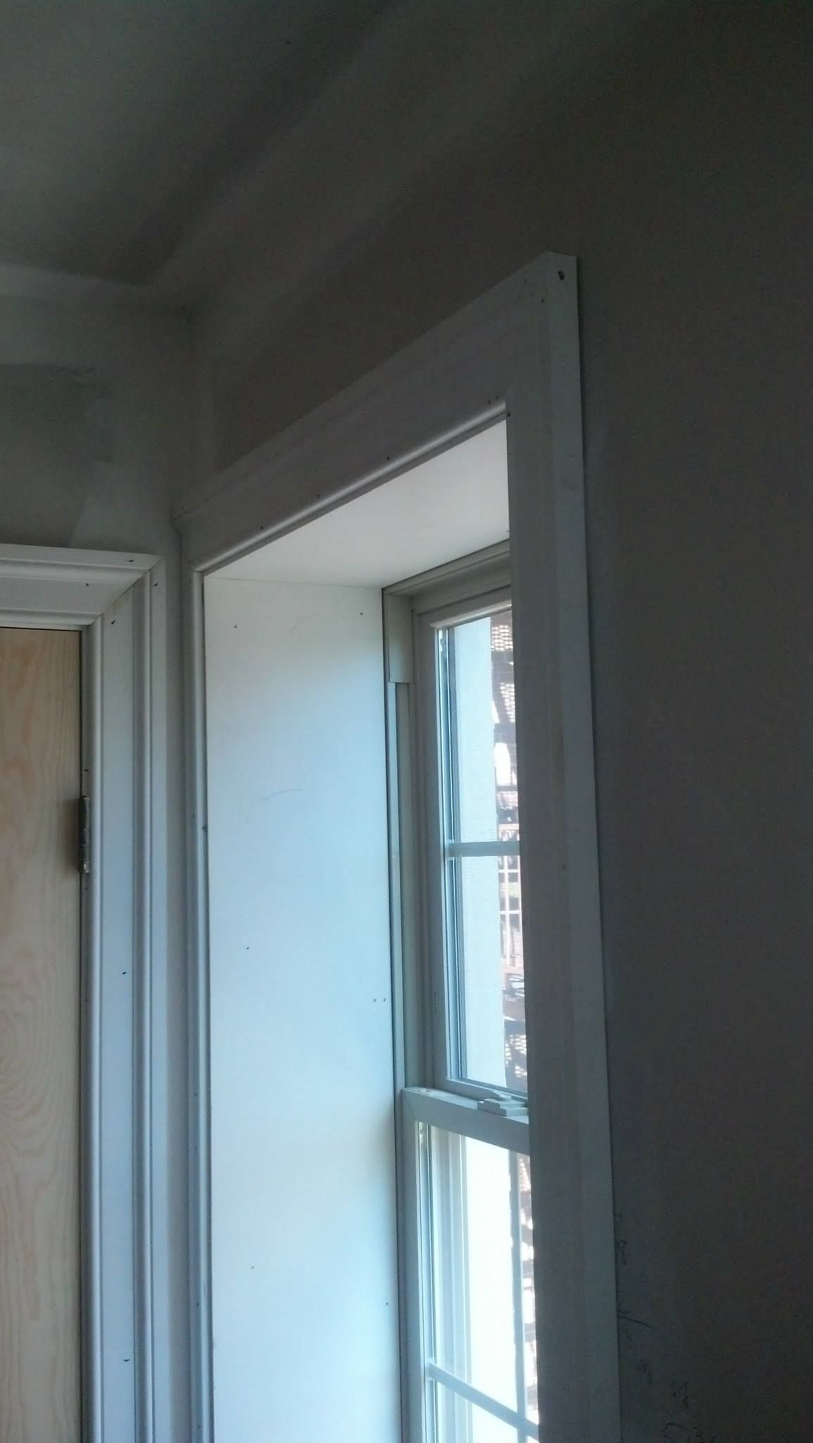 There is a window in the corner of the room.