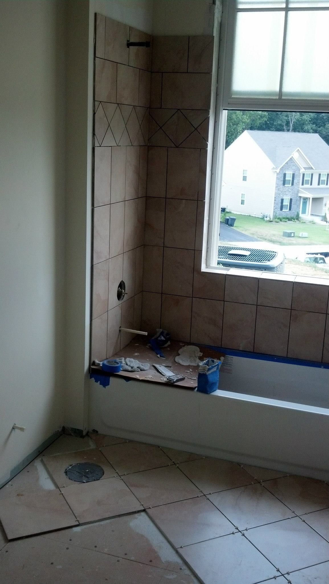 A bathroom with a bathtub and a window.