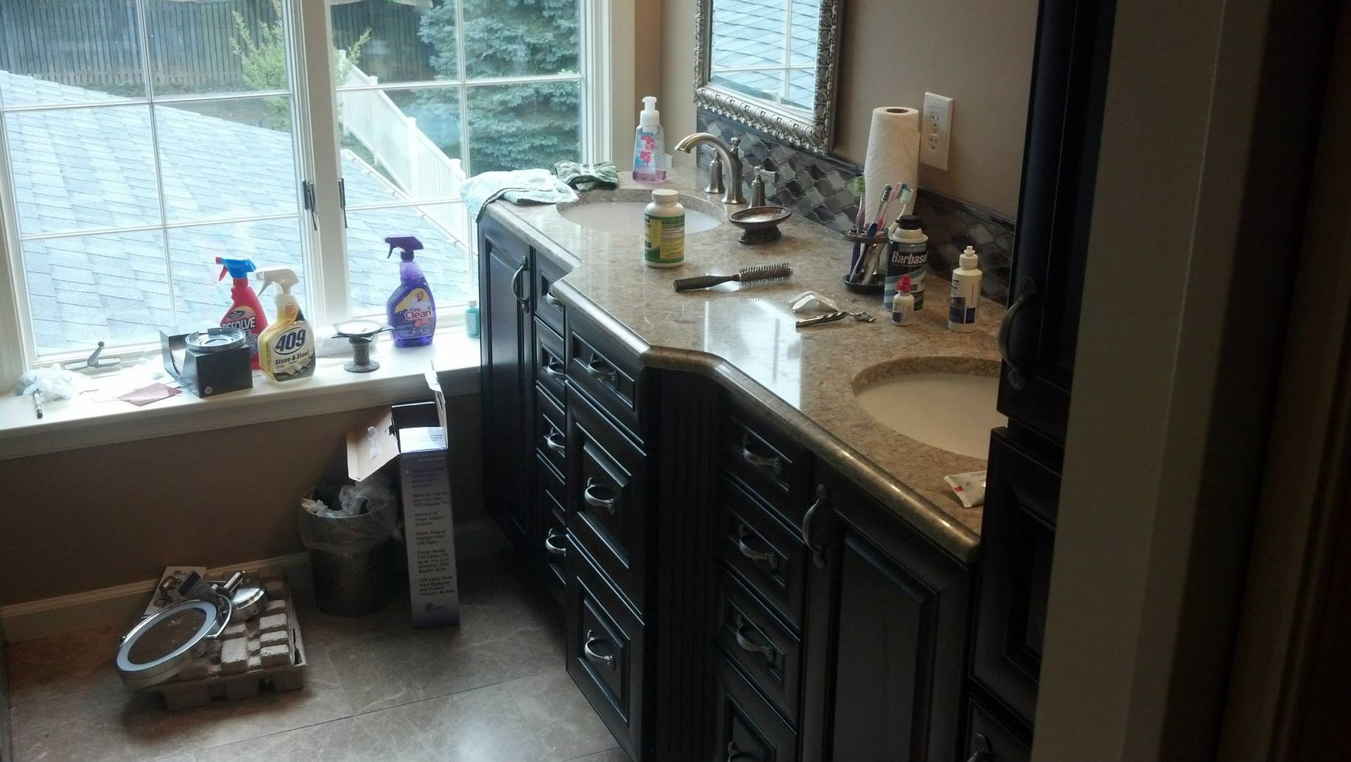 A bathroom with two sinks and a window.