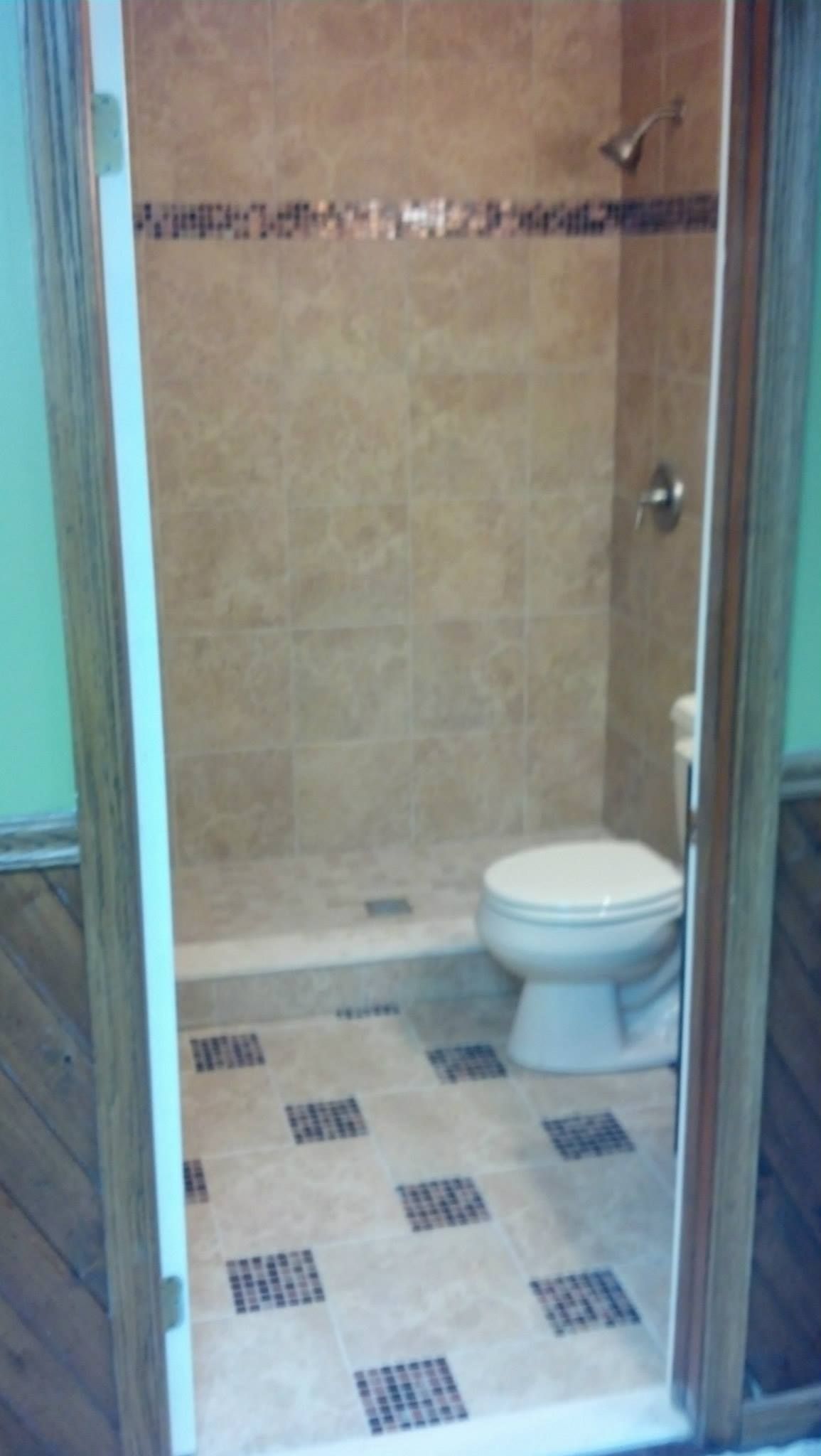 A bathroom with a toilet and shower in it