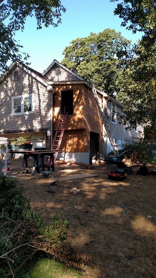 A house is being remodeled with a staircase going up to the second floor.