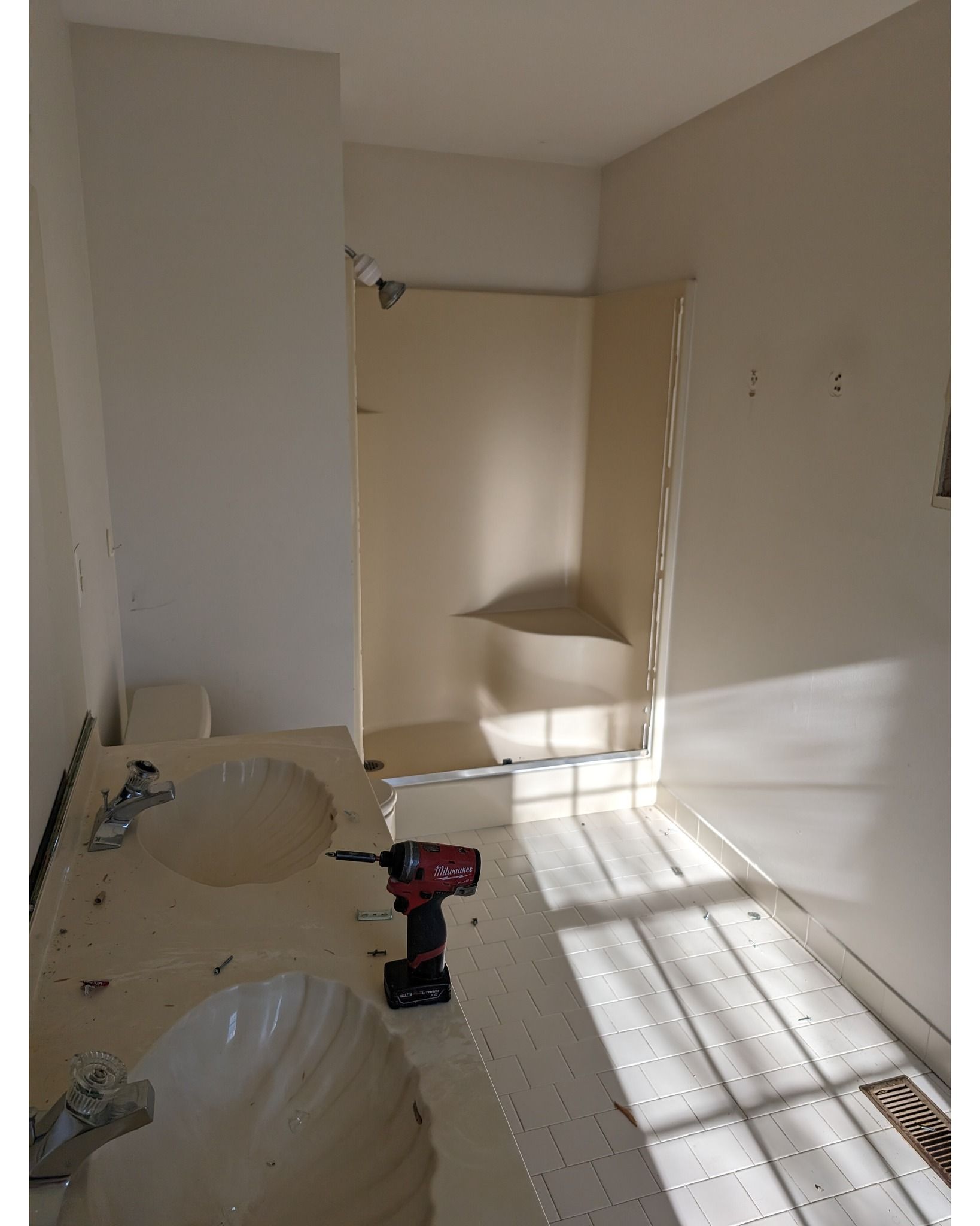 A bathroom with a sink , shower , and drill.