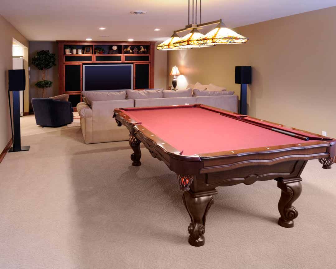 A pool table is in the middle of a living room
